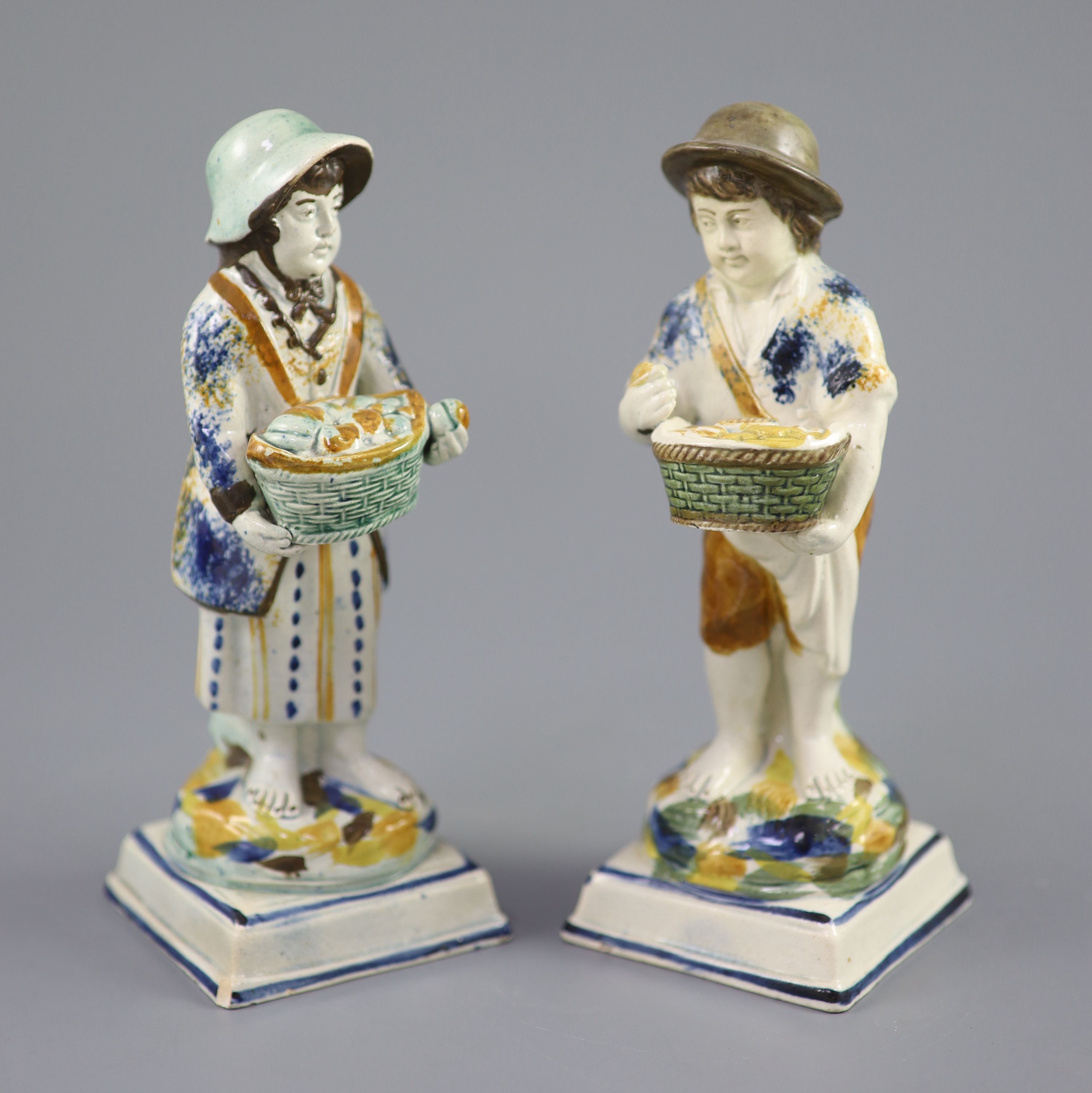 A pair of Prattware figures of fruit and biscuit street vendors, c.1790-1800, 17.5cm high